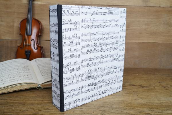 File folder with music paper and black linen edges